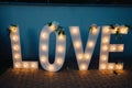 Big glowing love letters with light bulbs