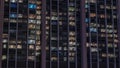 Big glowing windows in modern office and residential buildings timelapse at night