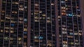 Big glowing windows in modern office and residential buildings timelapse at night