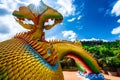 Big gold buddha and naga statue in Wat tham pha daen temple, the famous place of Sakon Nakhon Province, Thailand