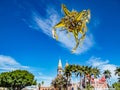 Mexican piÃÂ±ata against a blue sky, with a church and palmtrees in the background Royalty Free Stock Photo
