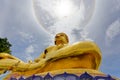 Big gold statue buddha under corona ring sun light Royalty Free Stock Photo