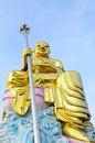 Big golden Bodhisattva statue with blue sky