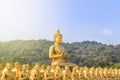 Big golden buddha statue and many small golden buddha statues sitting in thai temple Royalty Free Stock Photo