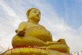 Big Golden Buddha statue over scenic white and blue sky at Wat S