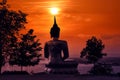 The big golden Buddha statue of Phu Salao temple in beautiful sunset moment at Pakse, Laos