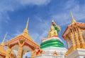 Big golden buddha statue sitting under green thai dragon statue in thai temple Royalty Free Stock Photo