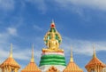 Big golden buddha statue sitting under green thai dragon statue in thai temple Royalty Free Stock Photo