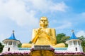 Big golden Buddha statue in wheel-turning pose in Dambulla Golden temple Royalty Free Stock Photo