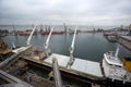 Big grain terminal at seaport. Cereals bulk transshipment from road transport to vessel. Loading grain crops on bulk