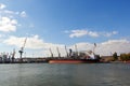 Big grain terminal at seaport. Cereals bulk transshipment from road transport to vessel. Loading grain crops on ship Royalty Free Stock Photo