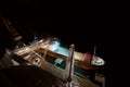 Big grain terminal at seaport. Cereals bulk transshipment from road transport to vessel at night. Loading grain crops on Royalty Free Stock Photo