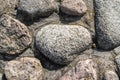 Big granite boulders or sea stones in ancient fortress walls