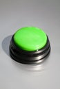 Big green buzzer for answers in a game show isolated on gray Royalty Free Stock Photo