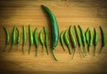 A big green chilli pepper in small Green chilli pepper on chopping block Royalty Free Stock Photo
