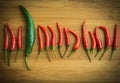 A big green chilli pepper in small Red chilli pepper on chopping block Royalty Free Stock Photo
