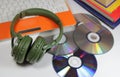 Big green earphones with disks and the computer Royalty Free Stock Photo