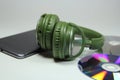 Big green earphones with l phone Royalty Free Stock Photo