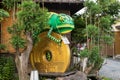 Kawagoe, Japan: Big green yellow chameleon and 5 jpy coin statue - money concept