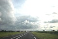 Big grey cumulus clouds above regional road N219 in the Zuidplaspolder at Zevenhuizen