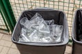 Big grey trach can full of used plastic transparent cups. Environment and world ocean pollution with plastic waste. Recycling mate Royalty Free Stock Photo