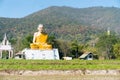 Big grotesque Buddhist monk statue in Thai countryside.