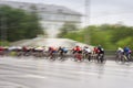 Big group of colorful racing cyclists on the city street, day, abstract, sport motion blurred background with copy space Royalty Free Stock Photo