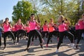 Feel Empowered and Energized: Join a Dynamic Piloxing Session with a Group of Energetic Women in Pink T-Shirts!