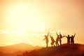 Happy friends or big family`s silhouettes at sunset mountains Royalty Free Stock Photo