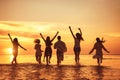 Big group of happy friends at sunset beach party Royalty Free Stock Photo