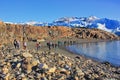 Big group of hiker people going to amazing melting Perito Moreno glacier along the scenic cost lake, Patagonia Argentina