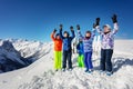 Big group of ski children stand on snow rise hands Royalty Free Stock Photo