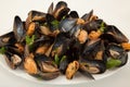 Big group steamed fresh mussels on white plate