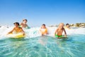 Happy friends swimming in the sea on body boards Royalty Free Stock Photo