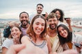 Big group of young adult multiracial friends taking a selfie portrait together for the social mediaon a friendly Royalty Free Stock Photo