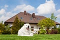 Big guard dog resting in front of the house. Polish Tatra Sheepdog