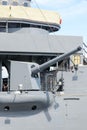 Big gun cannon on right side of warship. Safety boat on a ship Royalty Free Stock Photo