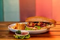 Big hamburger with french fries and ketchup on a wooden table Royalty Free Stock Photo