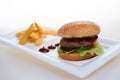 Big Hamburger with fries and ketchup on white bagkground Royalty Free Stock Photo