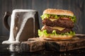 Big hamburger and mug of beer Royalty Free Stock Photo