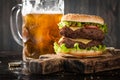 Big hamburger and mug of beer Royalty Free Stock Photo