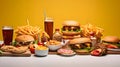 Big hamburgers with french fries and cold beer on yellow background Royalty Free Stock Photo