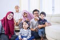 Big happy Asian muslim family watching tv happily Royalty Free Stock Photo