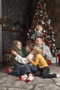 Big happy family at home, traditional xmas decorated living room. Mom dad and children near Christmas tree. Xmas holiday Royalty Free Stock Photo