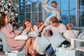 Big happy family with many kids having pillow fight under the Christmas tree on Christmas eve Royalty Free Stock Photo