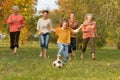 Big happy family playing football in autumn park Royalty Free Stock Photo