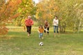 Big happy family playing football in autumn park Royalty Free Stock Photo