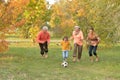 Big happy family playing football in autumn park Royalty Free Stock Photo