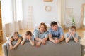 Big happy family posing near new purchased sofa in bright living room at home. Royalty Free Stock Photo