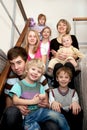 Big happy family sitting on the stairs at home. Royalty Free Stock Photo